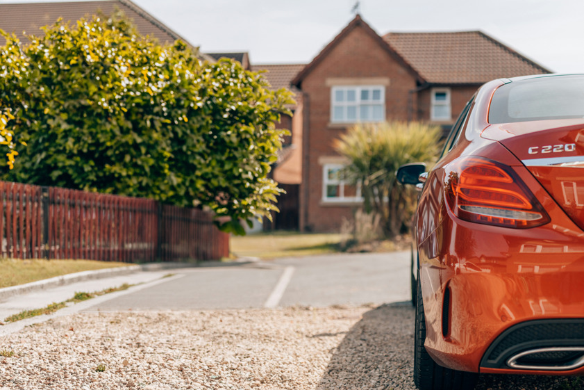 red Mercedes-Benz C220 parked on driveway